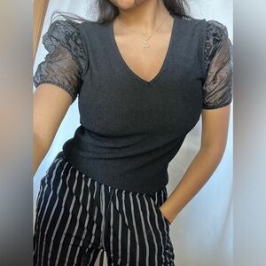 Black soft blouse. Has bubble sleeves and it’s super cute. never wore